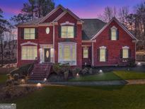 Stunning two-story brick home boasts immaculate landscaping, and a welcoming entryway with updated lighting at 4213 Bretdale Nw Run, Kennesaw, GA 30152