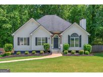 Charming single-story home featuring a well-manicured lawn and inviting entryway at 6645 N Glen Dr, Cumming, GA 30028
