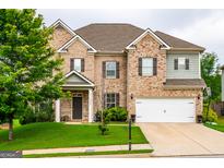 Traditional two-story brick home featuring an attached two-car garage and manicured front lawn at 4752 Albany Way, South Fulton, GA 30331