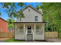 Charming two-story home featuring a welcoming front porch and classic architectural details at 786 Neal Nw St, Atlanta, GA 30318