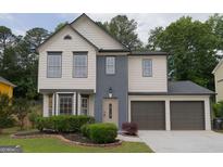 Charming two-story home with a well-manicured lawn and a two-car garage, perfect for a growing Gathering at 1075 Litchfield Sw Way, Marietta, GA 30060