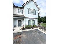 Charming two-story home with light blue siding and gray shutters at 7728 Fawn Cir, Covington, GA 30014