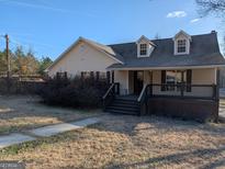 Charming single-story home featuring a welcoming front porch and well-maintained landscaping at 5700 Miles Rd, South Fulton, GA 30349