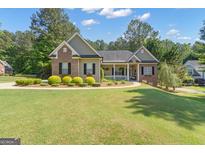 Charming home featuring a well-manicured lawn and inviting front porch at 150 Cold Harbor Ct, Sharpsburg, GA 30277