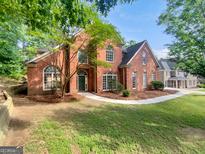 Stunning two-story brick home with lush landscaping and a welcoming curved walkway at 3832 Cherry Ridge Blvd, Decatur, GA 30034