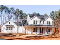 Charming farmhouse style home with a welcoming front porch and classic white siding at 253 E Crestwood Rd, Tyrone, GA 30290