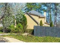 Charming home with a gray roof, light yellow siding, and a classic brick chimney at 2366 Battle Forest Sw Dr, Marietta, GA 30064