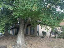 Traditional home exterior featuring a well-maintained lawn and mature trees at 2914 Parc Lorraine, Lithonia, GA 30038