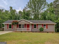 Charming single-story home with a well-maintained lawn and a welcoming front porch at 170 Hidden Pines Drive, Covington, GA 30016