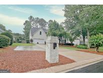 Charming two-story home with a manicured lawn and a driveway leading to an attached garage at 207 Tiverton Trl, Peachtree City, GA 30269