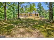 Cozy single-Gathering home surrounded by a natural, wooded landscape at 4950 Creel Rd, Fairburn, GA 30213