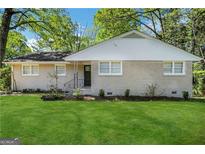 Charming single-story home with a well-manicured lawn and mature trees in a tranquil setting at 2896 Hogan Rd, East Point, GA 30344