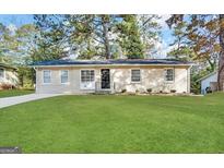 Charming single-story home with a well-maintained lawn and neutral exterior at 4390 Mercer Rd, Decatur, GA 30035