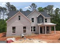 Beautiful new construction home with light brick facade and welcoming front porch at 3292 Mill Forest Sw Dr, Conyers, GA 30094