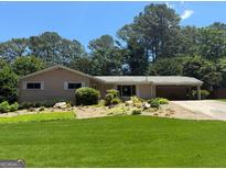 Charming single-story home with a well-manicured lawn and lush landscaping for excellent curb appeal at 1533 High Haven Ne Ct, Atlanta, GA 30329