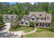 Beautiful two-story home with a charming front porch, mature landscaping, and a separate garage building at 193 Stonegate Trl, Carrollton, GA 30116