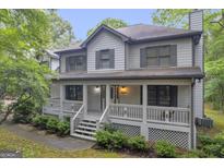 Charming two-story home with a welcoming front porch and lush landscaping at 392 Hightower Ridge Rd, Covington, GA 30014