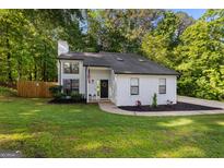 Charming two-story home with landscaped yard, fresh green grass, and beautiful curb appeal at 111 Rosignol Dr, Sharpsburg, GA 30277