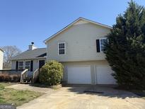 Two-story home with a two-car garage, wood deck and a well-maintained lawn at 132 Scarlett Place Dr, Bowdon, GA 30108
