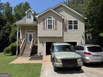 Charming two-story home with attached garage, complemented by a well-maintained lawn and driveway at 1432 Eagles Nest Cir, Carrollton, GA 30116