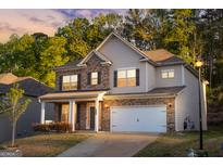 Beautiful two-story home with a brick and siding exterior and attached two car garage at 5229 Tye, Fairburn, GA 30213
