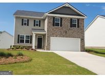 Two-story home with a brick and siding facade, a two-car garage, and a well-manicured lawn at 170 Aster Ave, Locust Grove, GA 30248