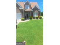 Charming two-story brick and stone home with a well-manicured lawn and inviting curb appeal at 7314 Basalt Dr, Union City, GA 30291