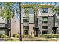 Townhome exterior boasts brick facade, modern design, and manicured landscaping at 710 Oakview Rd, Decatur, GA 30030