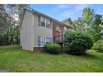 Charming two-story home with a combination of siding and brick exterior, complemented by a well-maintained lawn at 8915 Tweeddale Dr, Winston, GA 30187