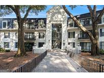 Charming condo building with striking architecture and mature trees at 2119 Pine Heights Ne Dr, Atlanta, GA 30324