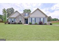 Charming single-Gathering home featuring a well-maintained lawn and stone accents at 234 Thyme Leaf Way, Locust Grove, GA 30248