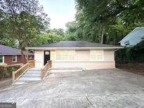 Charming single-story home with freshly painted exterior and inviting front entrance with wood stairs at 2239 Nelms Sw Dr, Atlanta, GA 30315