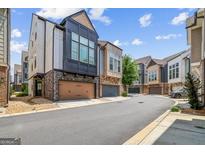 Stylish townhomes feature eye-catching architectural detail with a 2-car garage and neutral color palette at 1058 Kirkland Cir, Smyrna, GA 30080
