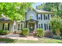 Charming two-story home with a welcoming front porch, a well-maintained lawn, and a traditional architectural style at 350 Ridgemont Dr, Fayetteville, GA 30215