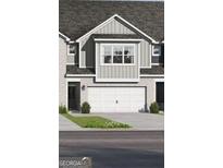 Two-story townhome featuring a two-car garage and neutral siding at 2306 Santa Fe St # 9, Morrow, GA 30260