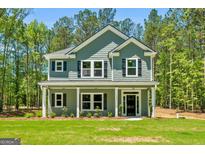 Charming two-story home showcasing a covered porch and manicured lawn at 1555 South Bethany Rd, Locust Grove, GA 30248