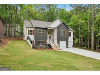 Beautiful two-story home with gray and white siding, wooden shutters, and a spacious front yard at 2279 Lakeview Pkwy, Villa Rica, GA 30180