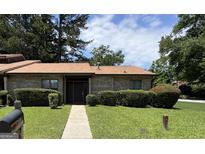 Charming brick home featuring a well-manicured lawn, mature trees, and welcoming front entrance at 5526 Stoneleigh Court, Stone Mountain, GA 30088