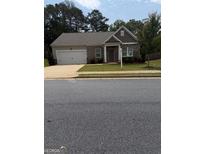 Charming single-story home featuring a brick facade, attached garage, and well-maintained front lawn at 170 Forray Dr, Covington, GA 30016