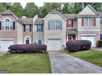 Charming townhouses with manicured lawns and colorful window shutters at 5640 Terremont Cir, Norcross, GA 30093
