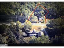 Expansive aerial view of the wooded lot and the property featuring the boundaries outlined in red at 905 John Ward Sw Rd, Marietta, GA 30064