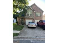 Charming brick home featuring an attached two car garage and a well-maintained front yard at 11657 Flemming Ct, Hampton, GA 30228