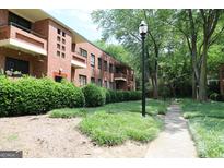 Brick building with green space and walkway leading to apartments, offering serene outdoor living at 1381 Ne Normandy Ne Dr # 4, Atlanta, GA 30306
