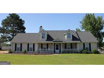 Charming single-story home with a well-manicured lawn and inviting front porch at 239 Ferguson Ave, Locust Grove, GA 30248
