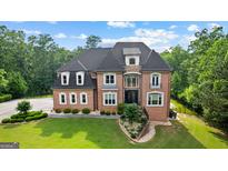 Beautiful two-story brick home with manicured lawn and lush landscaping at 4320 Blue Ridge Dr, Douglasville, GA 30135