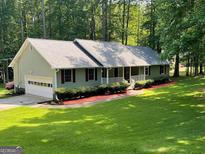 Charming single-story home with a welcoming front porch and well-maintained landscaping at 145 Adams Ct, Fayetteville, GA 30214