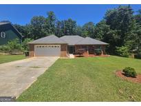Charming single-story brick home with a well-maintained lawn and attached two-car garage at 212 Hunting Court, Jonesboro, GA 30236
