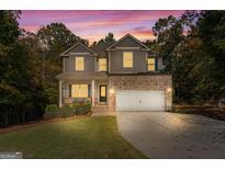 Inviting two-story home with brick accents, manicured lawn, and a spacious two-car garage at 1412 Short Ct, Mcdonough, GA 30252