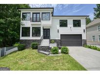 Two-story home boasts a brick and stone facade, an attached garage, and a well-manicured lawn at 2804 Skyland Ne Dr, Brookhaven, GA 30341