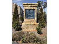 Community sign reads Hampton Preserve, surrounded by greenery and wrought iron fence at 190 Hampton Cir, Mcdonough, GA 30253